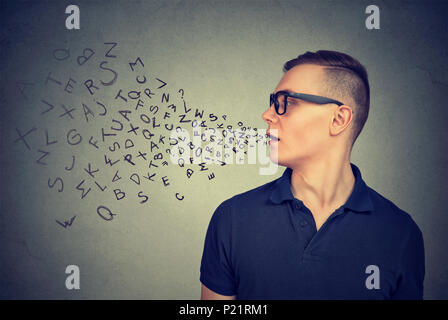 Man in glasses talking with alphabet letters coming out of his mouth. Communication, information, concept Stock Photo