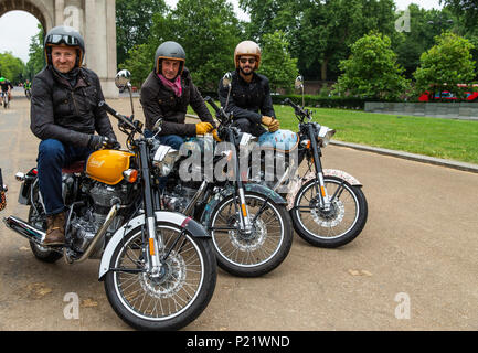 (Left to right) Michael Mann riding the Belstaff bike, Simon de Burton riding the House of Hackney bike and Tommy Clarke riding the Luke Edward-Hall & Saloni bike part of the make up the customised Royal Enfield fleet in front of the Wellington Arch for the Elephant Family's 'Concours d'Ã©lÃ©phant' dawn raid during the photocall in London. PRESS ASSOCIATION Photo. Picture date: Tuesday June 12, 2018. A customised fleet of 12 Ambassador cars, eight Royal Enfield motorbikes, a tuk tuk and a Gujarati Chagda made up the 'Concours d'Ã©lÃ©phant' - a cavalcade of designer inspired, quintessen Stock Photo