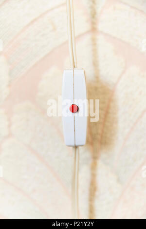 Old fashioned inline on/off switch with red button switch Stock Photo