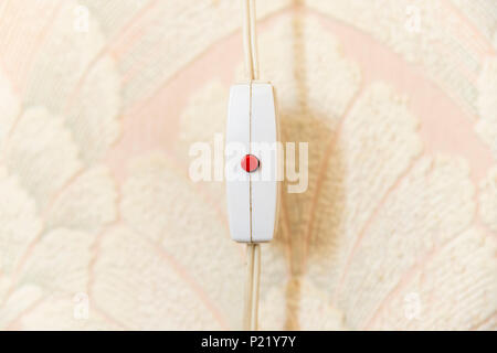 Old fashioned inline on/off switch with red button switch Stock Photo