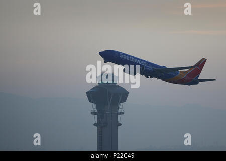Southwest Airlines Boeing 737-900 Passenger Jet Taking Off From Los Angeles International Airport, LAX, At Sunrise. The ATC  Control Tower Below. Stock Photo