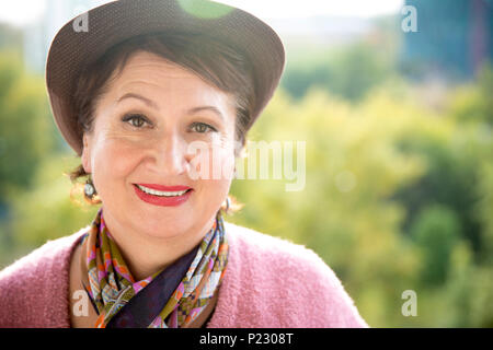 Headshot portrait of an amiable elderly woman smiling Stock Photo