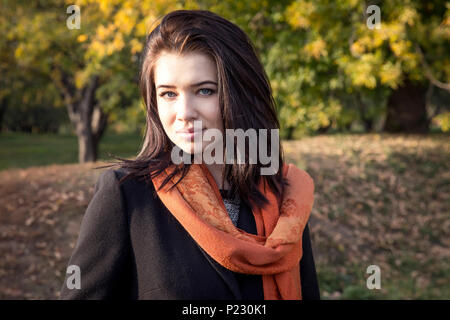Attractive young girl in a park in autumn Stock Photo