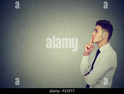 Thoughtful young business man making up his mind Stock Photo