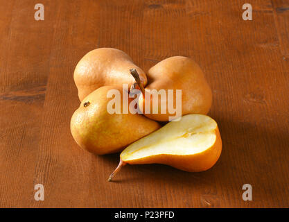 ripe bosc pears on wooden table Stock Photo