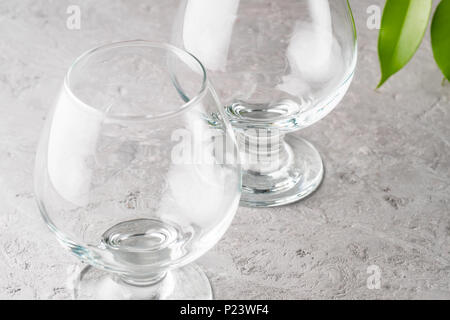 Two empty glasses for cocktails of cognac alcoholic drinks on a stone table preparation of preparation of beverages pure simplicity Stock Photo
