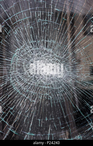 Broken glass / shattered glass shop window in Truro, Cornwall.  Metaphor recession, high street closures, vacant shops, vandalism, cracks glass. Stock Photo