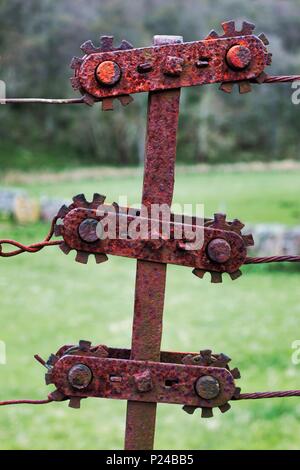 An old, rusty, fence tensioner on a Scottish farm Stock Photo