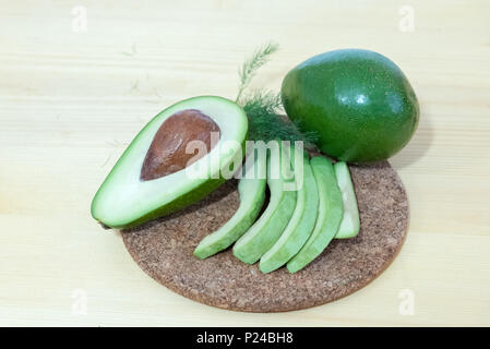 Fresh avocado fruit on wooden background Stock Photo