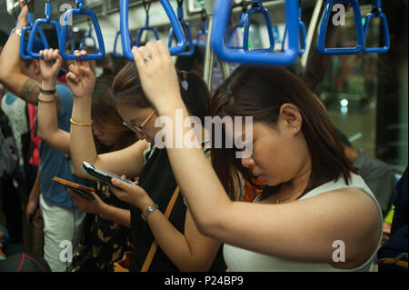 Singapore, Singapore, People in a subway Stock Photo