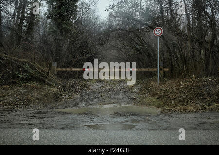 Forest way in winter, driveway, barrier, prohibitions signs, puddle, mud, Stock Photo