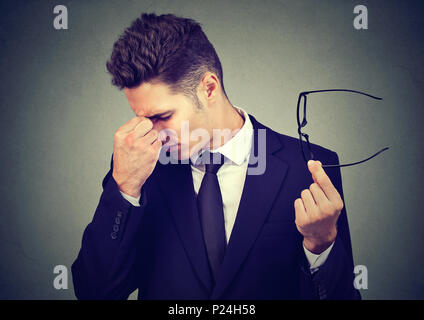 Young business man with glasses suffering from eyestrain Stock Photo