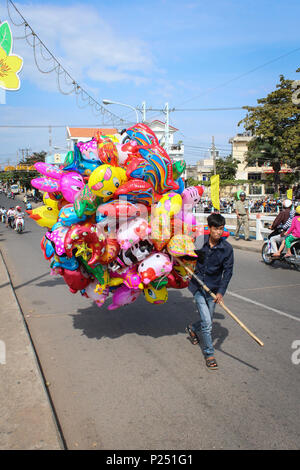 Phan Thiet , Vietnam - January 2014: Young vietnmese man selling colorful balloons on street during new year in Phan Thiet , Vietnam Stock Photo