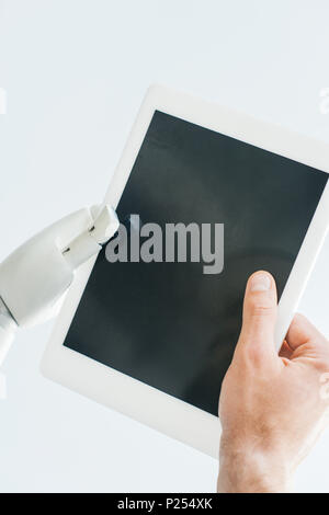 close-up view of human hand and robotic arm holding digital tablet with blank screen isolated on white Stock Photo