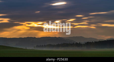 Sunrays break through the clouds in the Züricher Oberland / Zurich highlands Stock Photo