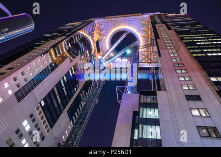 Osaka, Japan - April 28, 2017: looking up at the modern Umeda Sky Building in Kita-ku district by night. The Floating Garden Observatory is one of the Stock Photo