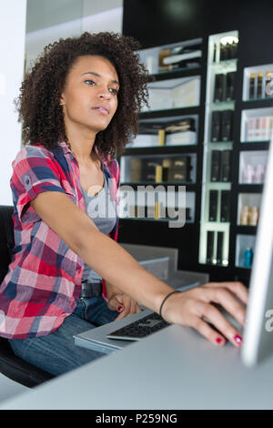 young woman administrator at his desk with a computer Stock Photo