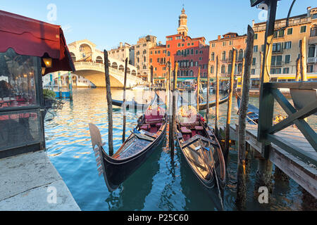 Two traditional venetian gondolas in front of Rialto Bridge, Canal Grande, Venice, Veneto, Italy Stock Photo