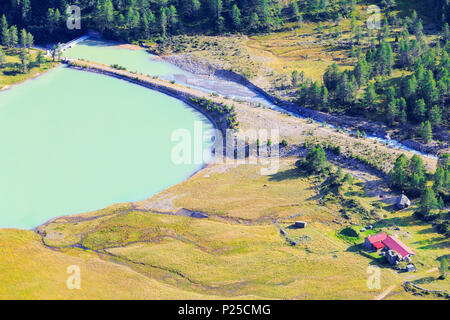 Farm and dam of Alp Palü from above, Alp Palü, Val Poschiavo, Graubünden, Switzerland. Stock Photo