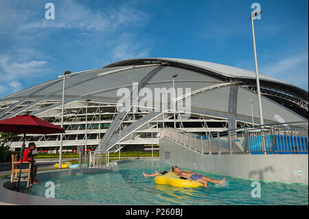 Singapore, Singapore, people in the outdoor pool, behind the national stadium Stock Photo