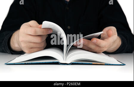 men's hands flipping through the pages of the book closeup Stock Photo