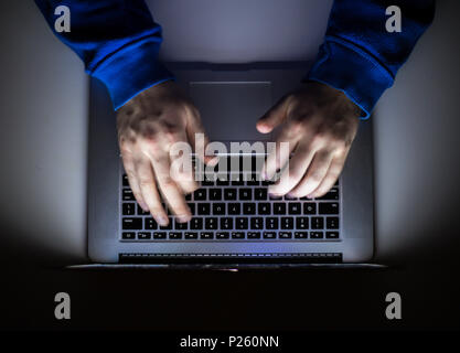 Cybercrime, a laptop hacker, writes codes to access unauthorized things, an illegal way, hacker, crime, cyber Stock Photo