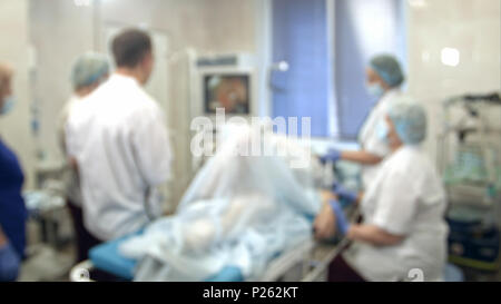 Doctors and nurses performing endoscopic procedure in hospital Stock Photo
