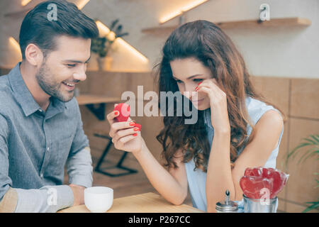 portrait of emotional woman with engagement ring wiping tears in cafe Stock Photo