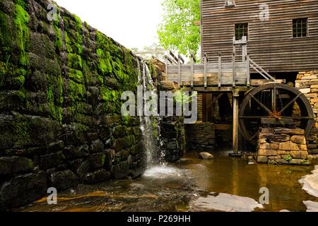 Green moss covers the dam of the old gristmill or watermill at Historic Yates Mill County Park in Raleigh North Carolina Stock Photo