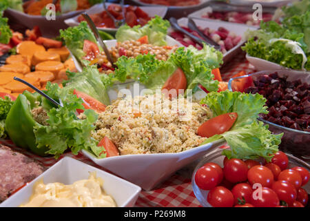 Tasted and various food and salads, tomatoes, taboule, sals in a restaurant table Stock Photo