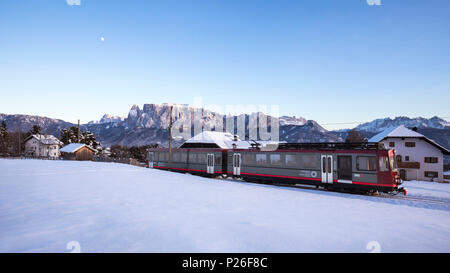 a view of the Renon's historic narrow-gauge railway with the Schlern in the background, Bolzano province, South Tyrol, Trentino Alto Adige, Italy, Europe Stock Photo