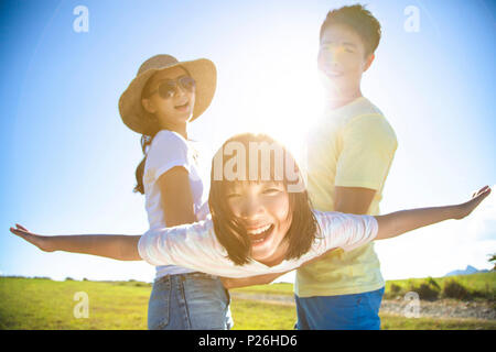 happy family playing on the grass Stock Photo