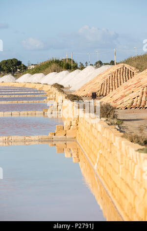 pyramids of salt drying along the salt pans of Marsala, Trapani province, Sicily, Italy Stock Photo