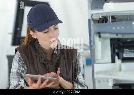 female technician using tablet computer Stock Photo