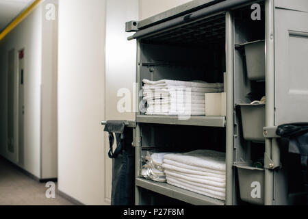 housekeeping cart with clean towels at hotel Stock Photo