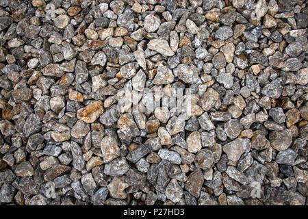 Close-up of gray stones of different sizes on the floor in the old town, background Stock Photo