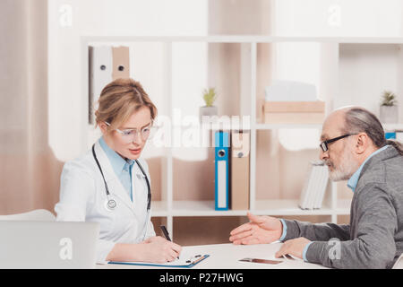 side view of senior patient at the doctors reception in clinic Stock Photo