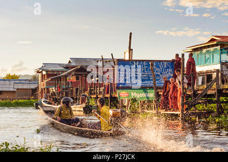 Maing Thauk, wooden bridge into Inle Lake, boat, monks, Inle Lake, Shan State, Myanmar (Burma) Stock Photo