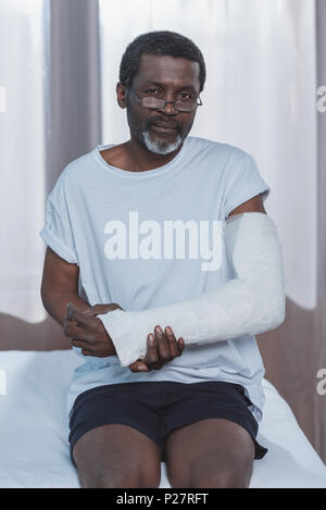African american patient with broken arm in plaster cast Stock Photo