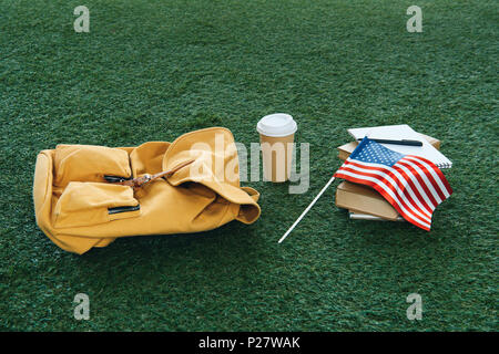vintage backpack and school supplies with usa flag on green grass Stock Photo