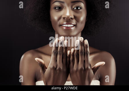 beautiful african american woman showing her nails isolated on black Stock Photo
