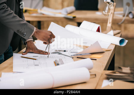 cropped shot of architect drawing architectural plans at workplace Stock Photo