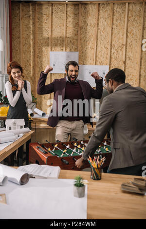 young architects playing table football at modern office Stock Photo
