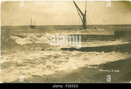 . Postcard photo of rough sea at Herne Bay, Kent, England. It shows a grounded barge near the beach and a ketch heading out to sea, and the title on the photo is ''Rescued', Herne Bay Aug 08'. The photographer was Fred C. Palmer of Tower Studio, Herne Bay, Kent, who is believed to have died 1936-1939. There is no border on this photograph. The stamp and postmark have been removed from the reverse, but the letter on the back was apparently written in the same year. Ethel writes to her mother Mrs Green in Bournemouth, Hampshire, saying, 'Will write you a letter in the morning and tell you all ab Stock Photo