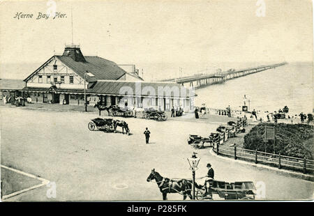 . Postcard of Herne Bay Pier, Herne Bay, Kent, unused, but identical to the tinted version (listed below) which is postmarked 1905. The photographer was Fred C. Palmer, who died in 1941. At the time of this photograph he was probably still working from Herne Bay High Street, as his Tower Studio address does not appear alongside his name on the back of the card. Points of interest  The Grand Pier Pavilion was not yet built; it was completed in 1910. The theatre building in the foreground burned down in 1928. On the right hand side of the shops alongside the theatre building, can be seen part of Stock Photo