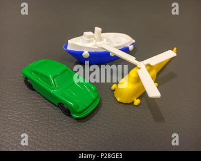 Plastic car, boat and helicopter. Different types of transportation. Stock Photo