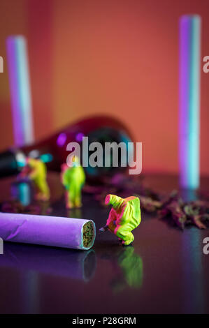 Miniature hazmat team inspects hazardous tobacco products Stock Photo