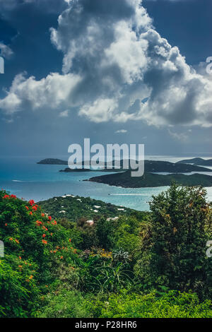 Aerial, vertical view on the turquoise sea and green hills around. Stock Photo