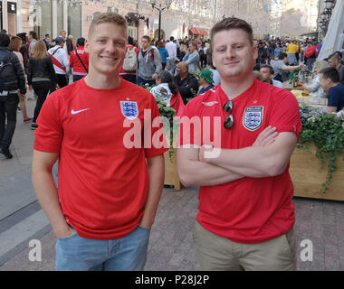 RETRANSMITTING CORRECTING NAME England fans Daniel Swaisland (left) 21, from Andover, in Hampshire and James Ellis, 23, from Devizes, Wiltshire, wearing their England shirts, as they take in the atmosphere of Nikolskaya Street, near Red Square, which was packed with thousands of football fans from other nations. England fans have begun to venture out in Moscow in team colours as anticipation builds for the opening of the World Cup. Stock Photo