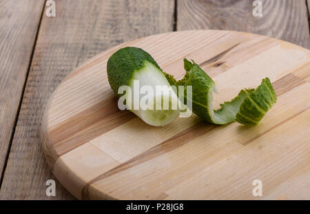 Curls of peelings cucumber on a cutting board Stock Photo